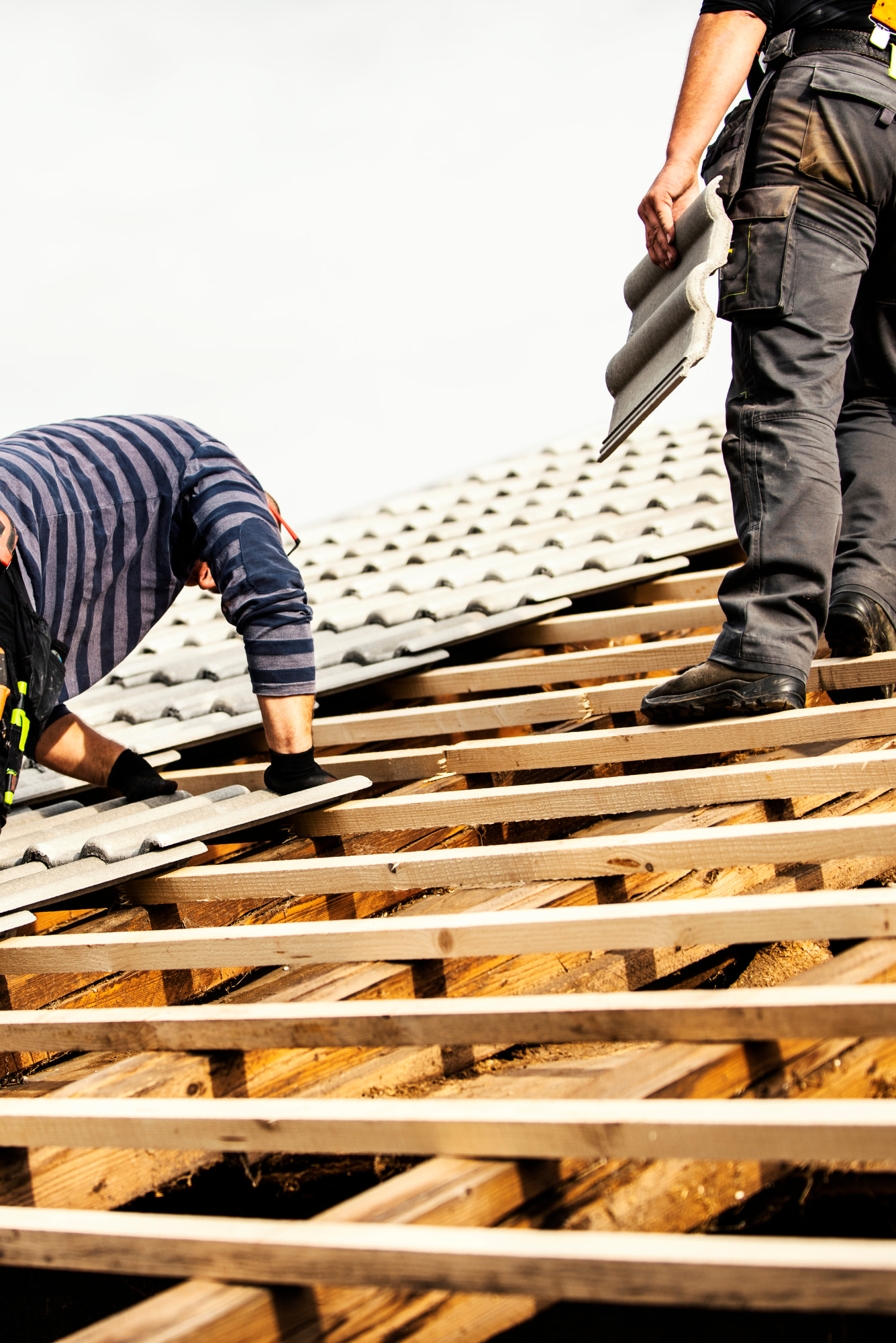 Professional roofers working on a residential roof